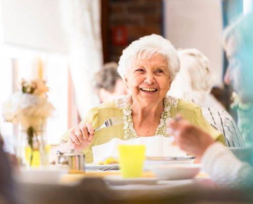 Portrait photo of a senior woman having lunch